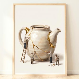 May include: A framed wall art print depicting a large, off-white ceramic teapot with gold-filled cracks. Four miniature figures in work clothes are shown repairing the teapot, with one on a wooden ladder and others using tools on the surface.