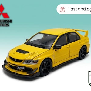 May include: A bright yellow Mitsubishi Lancer Evolution toy car with black wheels and a rear spoiler. The car has the text "Fast and agile!" in a white oval and the Mitsubishi Motors logo.
