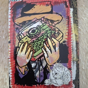 May include: A colorful illustration featuring a person in a suit and hat, holding a typewriter. The typewriter is green, yellow, and pink. The illustration has a red border and the text "LEE" is visible in the top left corner.
