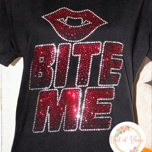 May include: Black t-shirt with a red rhinestone design that says "Bite Me" with a red rhinestone vampire mouth above the text.