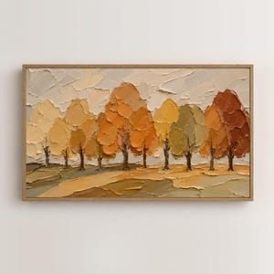 May include: A rectangular landscape painting in a wooden frame featuring a row of trees with thick, textured impasto brushstrokes. The color palette consists of warm autumn tones including shades of cream, beige, golden yellow, orange, and brown.