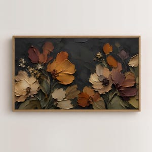 May include: A rectangular wall art piece featuring a thick, textured oil painting of flowers in shades of ochre, burnt orange, cream, and deep brown against a dark charcoal background, all enclosed within a simple light-toned wooden frame.