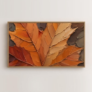 May include: A rectangular wall art piece featuring a thick impasto oil painting of a large maple leaf. The artwork displays a palette of warm autumn colors including burnt orange, deep brown, tan, and copper tones, framed in a light wood border.