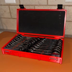 May include: A set of chrome wrenches neatly arranged in a red plastic case. The case is open, revealing the tools in a black foam insert. The wrenches are labeled with size measurements in inches.