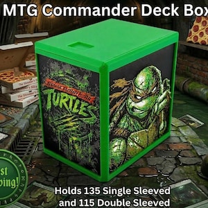 May include: Green MTG Commander Deck Box featuring Teenage Mutant Ninja Turtles artwork. The box holds 135 single-sleeved or 115 double-sleeved cards. The box has a green frame and a black background with a TMNT graphic.