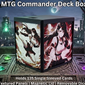 May include: A white ceramic mug with a black handle and the text "But First, Coffee" in a bold, black font. The mug is set against a blurred background, suggesting a cozy setting.