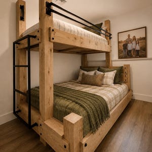 May include: A bunk bed constructed from light-toned wood featuring a black metal ladder and black metal safety rails on the top bunk. The bed is dressed with a plaid comforter, a green knit throw blanket, and several decorative pillows.