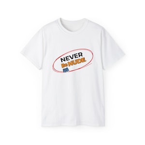 May include: White crew neck t-shirt with the text "NEVER Be NUDE" in a red oval. The design includes a small blue shorts graphic. The shirt is made of a soft, comfortable material.