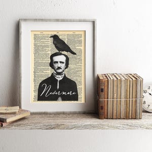 May include: Framed art print featuring a black and white illustration of Edgar Allan Poe with a raven on his head, set against a vintage book page background. The word "Nevermore" is written in script. A stack of books and a clock are on the shelf.