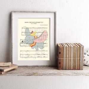 May include: Framed print featuring sheet music and a cartoon illustration of Dumbo the elephant. The image includes the text "WHEN I SEE AN ELEPHANT FLY". A stack of books and a clock are on a wooden shelf.