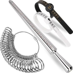 May include: A metal ring mandrel with printed size markings, a set of silver-colored metal ring sizers on a cable, and two plastic ring sizer belts in black and white with numerical markings for measuring finger circumference and ring size.