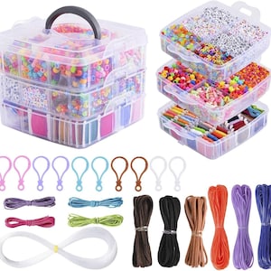 May include: A clear, three-tiered craft organizer filled with colorful beads, string, and accessories. The organizer has a black handle and multiple compartments. Additional craft supplies include colorful clasps and various cords and strings.
