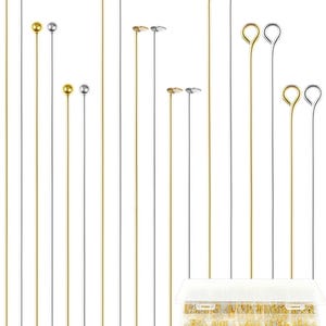 May include: A collection of long metal headpins and eyepins in gold and silver tones, featuring various top designs including ball, flat, and loop ends. A clear plastic storage container with multiple compartments holds a large quantity of pins.