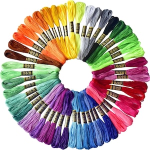 May include: A circular arrangement of colorful embroidery floss skeins. The floss is in a rainbow of colors, including yellow, orange, brown, green, blue, purple, pink, and red. Each skein is wrapped with a paper band.