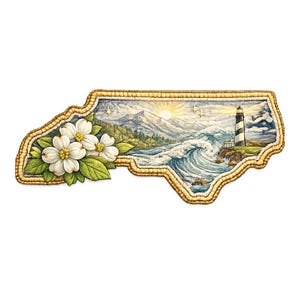 Può includere: Un oggetto decorativo a forma di stato della Carolina del Nord, raffigurante una scena costiera con un faro, onde e montagne. Fiori bianchi di corniolo e un bordo dorato incorniciano l'immagine. Il sole tramonta sullo sfondo.