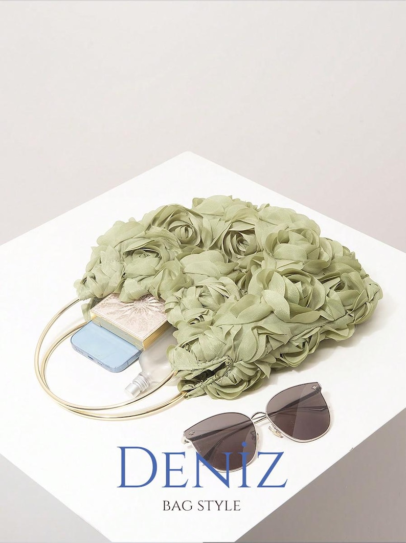 May include: A light green floral handbag with a gold handle, sunglasses, a blue phone, and a small cosmetic case. The bag is filled with items and sits on a white surface. The text "DENIZ BAG STYLE" is at the bottom.