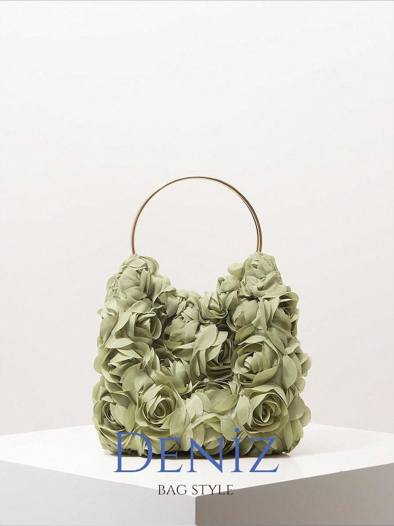 May include: A sage green handbag with a gold-colored handle. The bag is covered in fabric roses. The text "DENIZ BAG STYLE" is printed in blue at the bottom of the image.