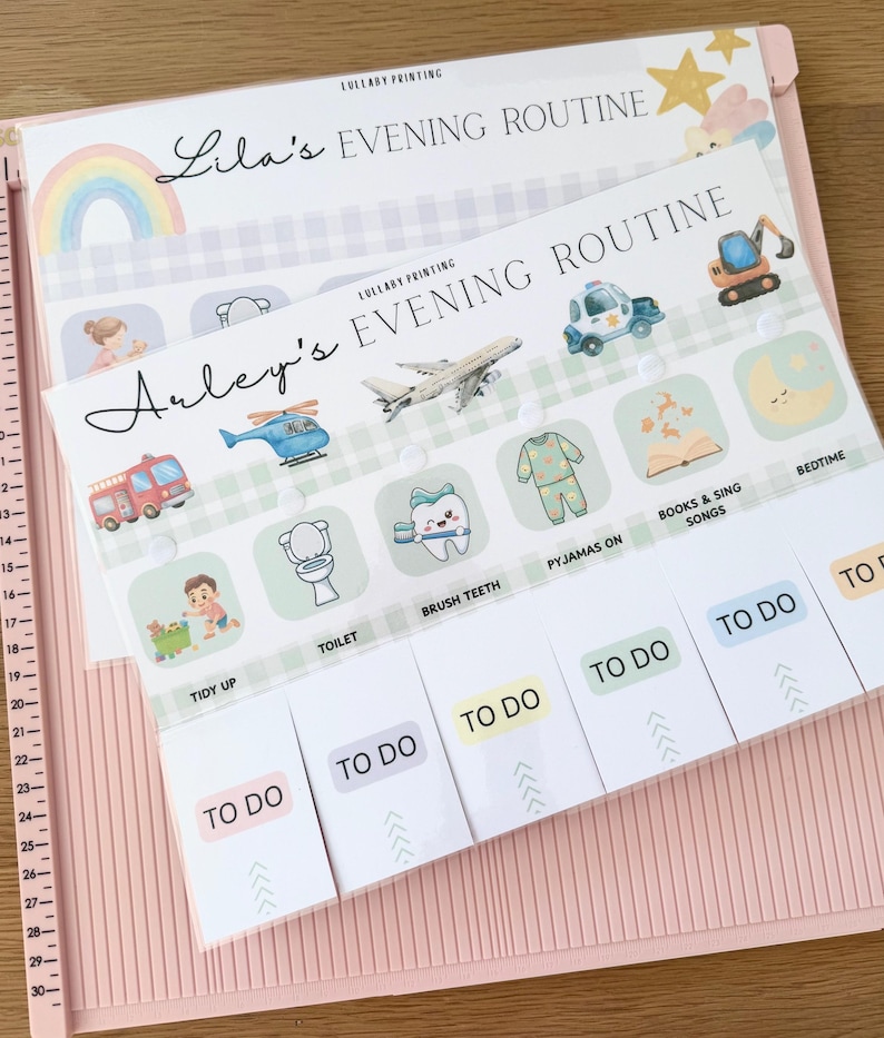 May include: A paper evening routine checklist for children titled Arley's Evening Routine, featuring illustrations of a fire truck, helicopter, airplane, police car, and excavator, with sliding tabs labeled TO DO for tasks like tidy up, toilet, brush teeth, and bedtime.