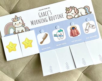 Könnte beinhalten: Ein weißes Papierdiagramm mit dem Titel Grace's Morning Routine, das Zeichentrick-Einhörner, Regenbögen und Sterne zeigt. Es enthält interaktive Klappen mit Symbolen zum Haarekämmen, Zähneputzen, Anziehen eines Mantels und Anziehen von Schuhen.