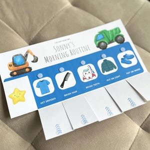 May include: A white and blue morning routine chart titled Sonny's Morning Routine featuring illustrations of a construction vehicle, a dump truck, and a yellow star. It includes five task icons with labels: Get Dressed, Brush Hair, Brush Teeth, Put On Coat, and Put On Shoes.