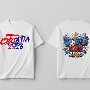 May include: A white short-sleeved t-shirt shown from the front and back. The front features the text Croatia 2026 with a Croatian flag and football. The back displays a World Cup 2026 graphic with a trophy, football, and stadium floodlights.