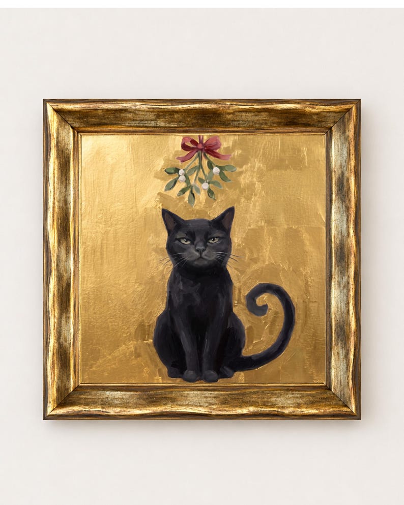 May include: A framed painting of a black cat sitting centered against a textured gold background. Above the cat, a sprig of mistletoe with white berries is tied with a red ribbon. The artwork is enclosed in a distressed gold-toned frame.