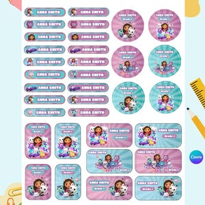 May include: A sheet of colorful labels featuring the name "ANNA SMITH" in various shapes and sizes. Some labels include illustrations of cartoon characters and the text "Grade 1". The labels are in shades of pink, blue, and purple.
