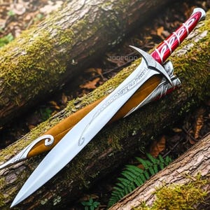 May include: A set of three ceramic mugs with a speckled, cream-colored glaze. Each mug features a different hand-painted floral design in shades of blue, green, and yellow. The mugs have a simple, modern shape.