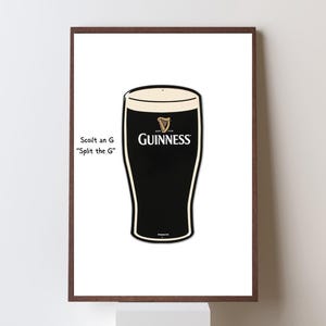 May include: A framed print featuring a stylized illustration of a pint of Guinness stout. The glass is black with a creamy white head, and the Guinness logo is prominently displayed. Text on the left reads "Scoil an G, Split the G."