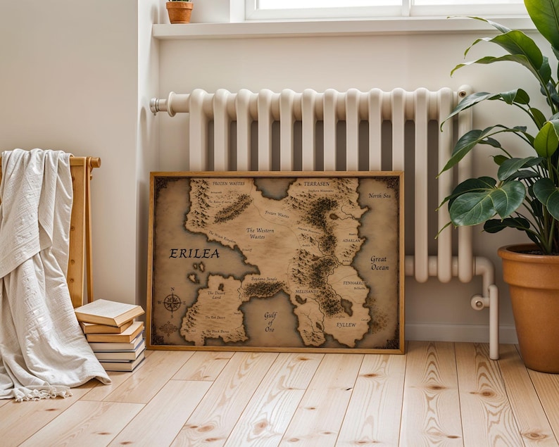 Vintage style fantasy map printable wall art of a mythical continent with detailed kingdoms and mountains. Aged parchment paper look, perfect for dark academia decor and book lovers room styling.