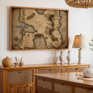 Vintage style fantasy map printable wall art of a mythical continent with detailed kingdoms and mountains. Aged parchment paper look, perfect for dark academia decor and book lovers room styling.