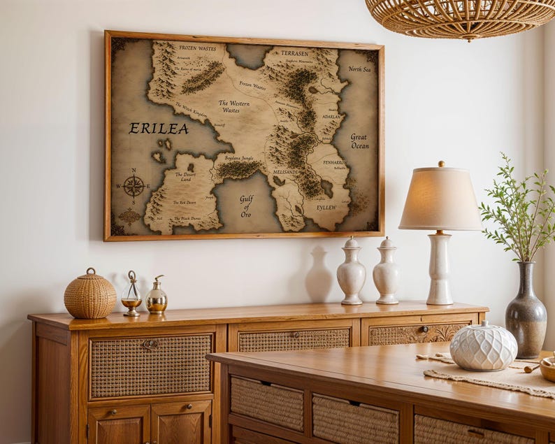 Vintage style fantasy map printable wall art of a mythical continent with detailed kingdoms and mountains. Aged parchment paper look, perfect for dark academia decor and book lovers room styling.