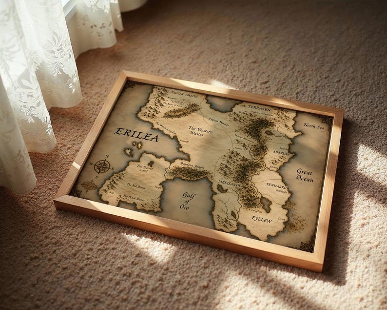 Vintage style fantasy map printable wall art of a mythical continent with detailed kingdoms and mountains. Aged parchment paper look, perfect for dark academia decor and book lovers room styling.