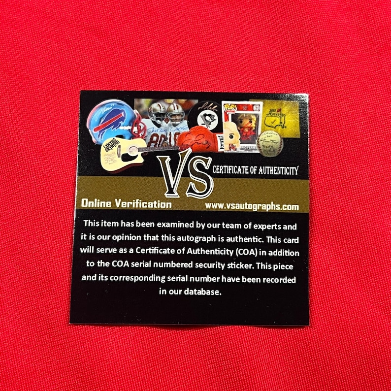 May include: A black and gold Certificate of Authenticity card with the text "VS" and "Certificate of Authenticity". The card includes images of sports memorabilia and the text "Online Verification" and "www.vsautographs.com".