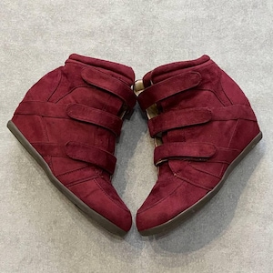 May include: A white ceramic mug with a black handle and the text "But First, Coffee" in a bold, black font. The mug is sitting on a white surface. The mug is approximately 4 inches tall.