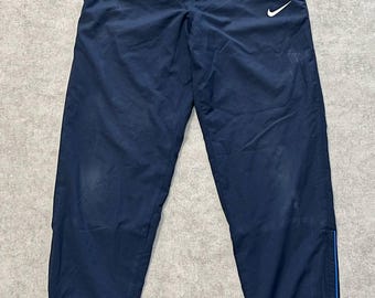 Pantalones deportivos Nike vintage de nailon azul con logo Swoosh de los años 2000, talla M.