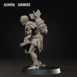 May include: A grey miniature figurine from Ashen Armies depicting a humanoid figure with a helmet, carrying a large bomb strapped to its back with rope. The figure wears tattered clothing, features cross symbols on its body, and holds a rectangular object.