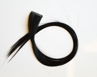 Black hair extension clip in