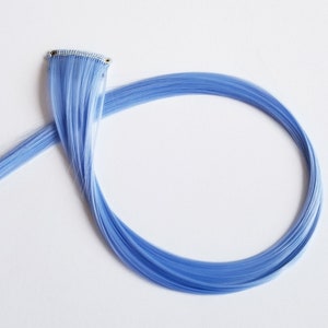 Pastel blue hair extension clip in