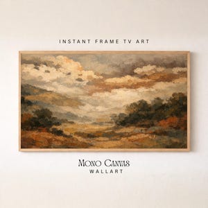 May include: A rectangular landscape painting in a wooden frame featuring a cloudy sky over a field with trees. The text INSTANT FRAME TV ART appears above the frame, and MONO CANVAS WALLART appears below the frame in black lettering.