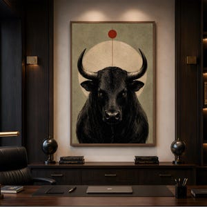 May include: A framed wall art print featuring a detailed portrait of a black bull with large horns. Behind the bull is a large, pale circular shape with a thin vertical line extending upward to a small, solid red circle against a muted green background.