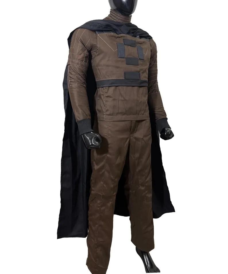 May include: A brown costume with a black cape, gloves, and a head covering. The costume features a jacket with square patches and a matching pair of pants. The outfit is displayed on a mannequin.