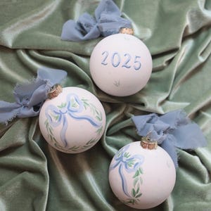 Précommande 2026 : Ornement peint à la main, couronne à nœud bleu, premier Noël de bébé garçon 2025, cadeau personnalisé
