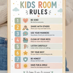 May include: A framed print featuring "KIDS ROOM RULES" in colourful letters. The print lists eight rules with icons, including "Be Kind," "Share with Others," and "Have Fun & Smile." The bottom reads "Be happy. Be you. Be amazing!"