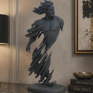 May include: A dark grey sculpture of a human figure with flowing hair and a torso that transitions into abstract, jagged, vertical shards. The figure is depicted in a dynamic, forward-leaning pose, mounted on a circular base with a matte finish.