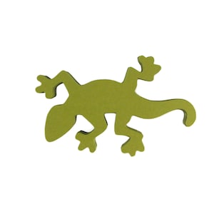 May include: A green felt cutout of a gecko lizard. The gecko is facing left and has a long tail.