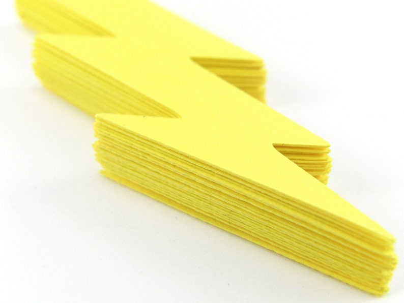 May include: A stack of yellow lightning bolt shaped paper cutouts.