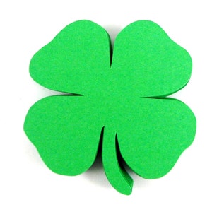 May include: A green four-leaf clover cutout, a symbol of good luck.