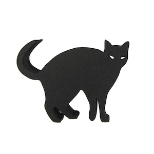 May include: Black silhouette of a cat with a curled tail. The cat is facing forward with its ears perked up.