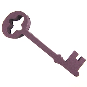 May include: A purple paper key cutout. The key has a large, round head with a star-shaped hole in the center. The key has a long, thin shaft and a small, rectangular handle.